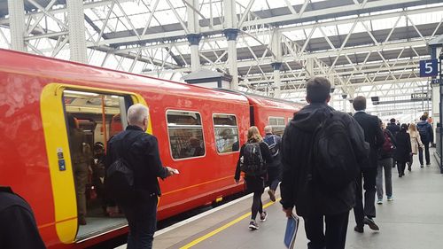 People in train at railroad station platform