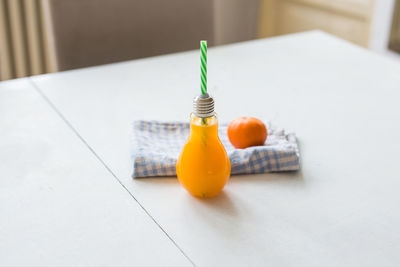 Close-up of light bulb on table