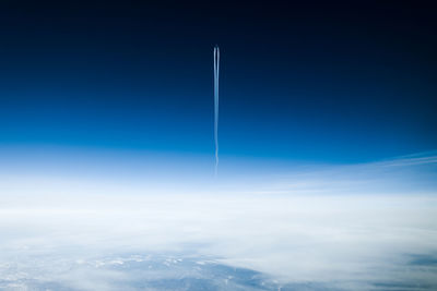 Low angle view of vapor trail against blue sky