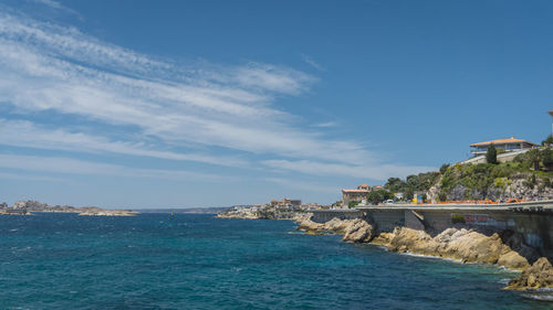 Scenic view of sea against sky in city