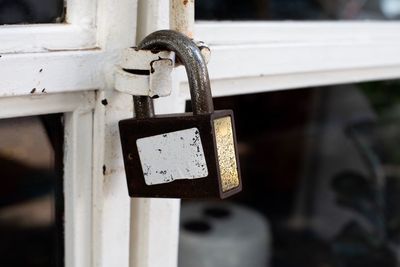 Close-up of padlocks on metal railing