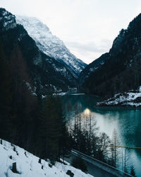 Scenic view of snowcapped mountains by lake against sky