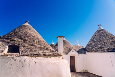 Exterior of old building against clear blue sky