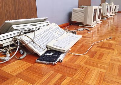 Computer monitors and keyboards on hardwood floor