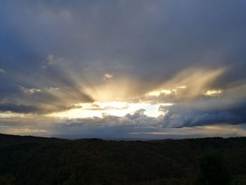 Scenic view of silhouette landscape against sky at sunset