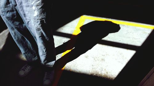 Close-up of man's shadow on floor