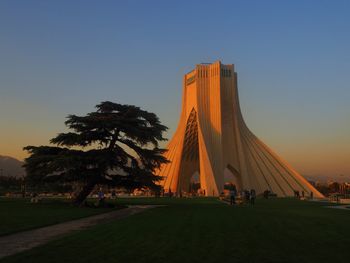 Azadi tower against clear sky during sunset