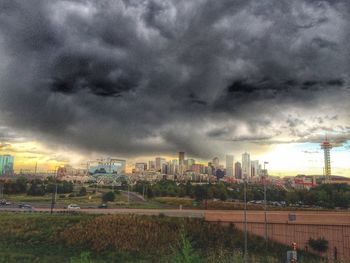 Cityscape against cloudy sky