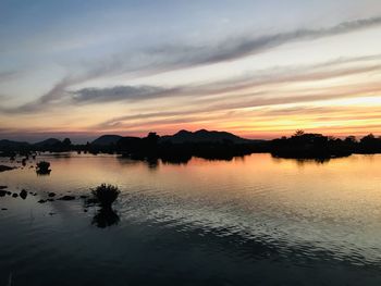 Scenic view of lake against sky during sunset