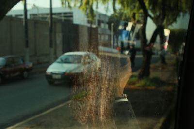 Close-up of wet car on road