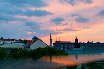 Scenic view of city against sky at sunset