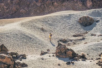 Midsection of man on rock