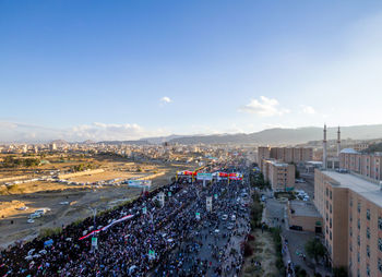 High angle view of road by buildings against sky