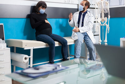 Side view of doctor examining patient in laboratory