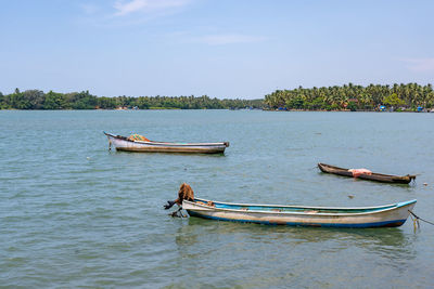 Boat moored in sea against sky