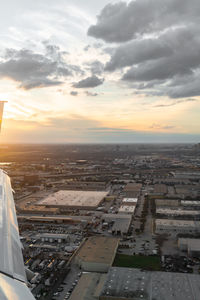 High angle view of city buildings against sky during sunset