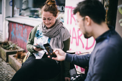 Young couple holding smart phone
