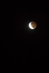 Low angle view of moon against sky at night