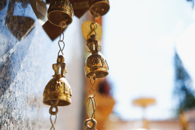 Low angle view of electric lamp hanging on ceiling