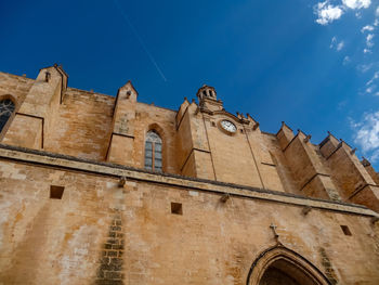 Low angle view of building against blue sky