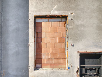 Bolted windows and a walled door on the facade of an abandoned building
