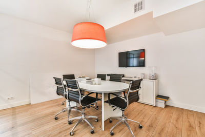 Table and chairs on floor against wall at home