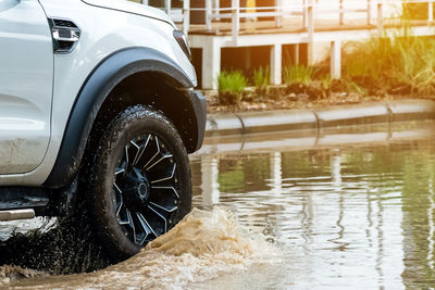 Pickup truck passing through flooded road. driving car on flooded road during flood.