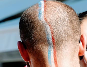 French flag painted on head of man