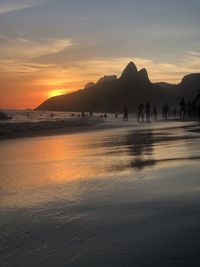 Scenic view of beach against sky during sunset