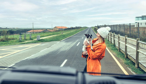 View from inside camper van of woman with her dog