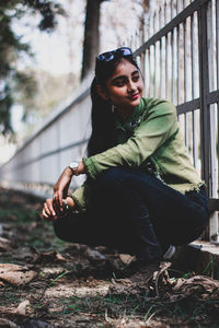 Portrait of young woman sitting outdoors