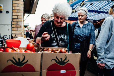 People holding food on table at market