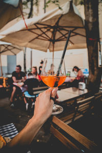 Close-up of hand holding drink in restaurant