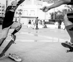 Men skateboarding at park