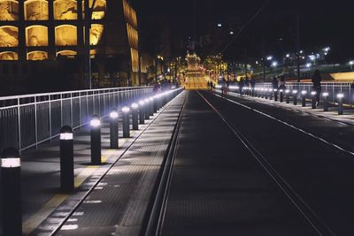 View of illuminated railroad tracks at night