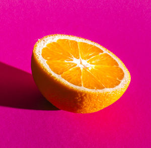Close-up of apple against pink background