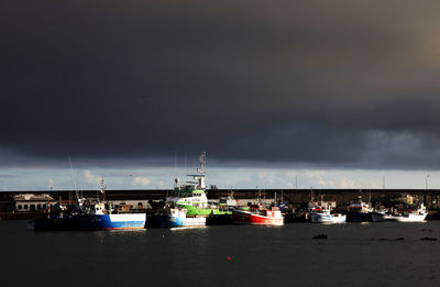 Boats moored at harbor