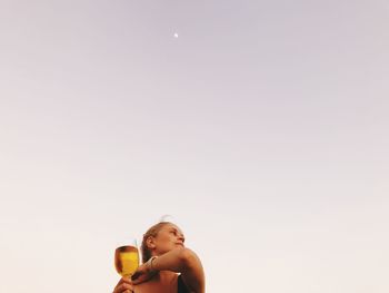 Portrait of a young woman drinking glass