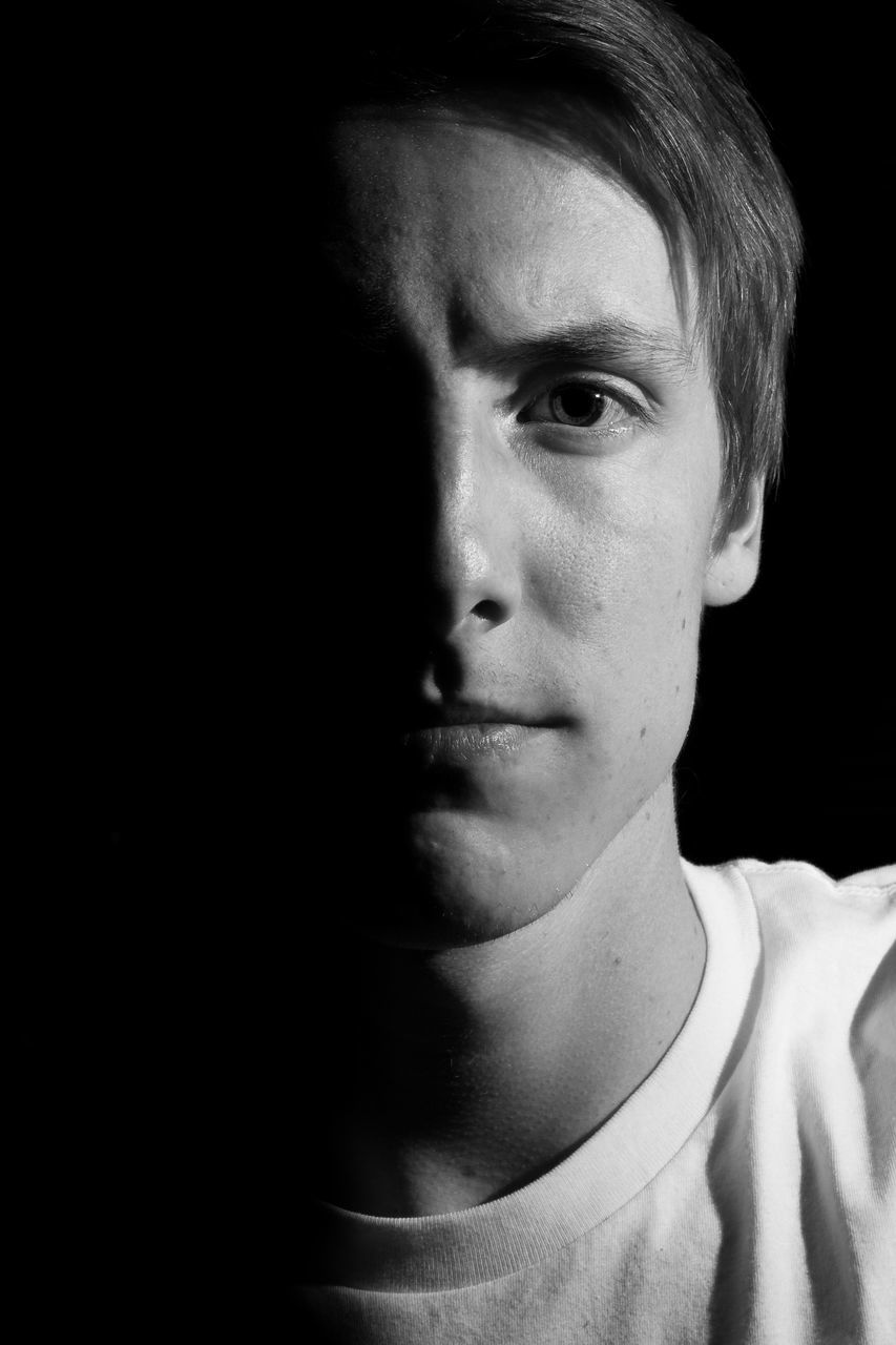 headshot, black background, young adult, lifestyles, studio shot, portrait, indoors, looking at camera, close-up, person, human face, serious, front view, contemplation, leisure activity, head and shoulders, young women