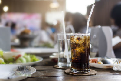 Glass of cola on table at the lunch time