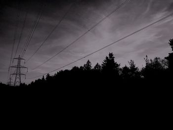 Silhouette of power lines against sky at sunset