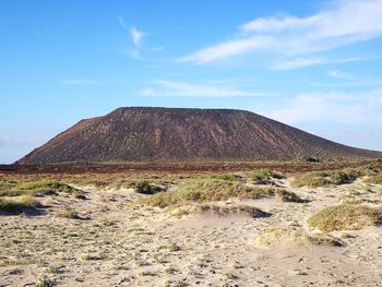 Scenic view of arid landscape against sky