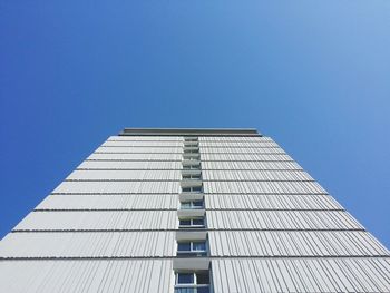 Low angle view of modern building against clear blue sky