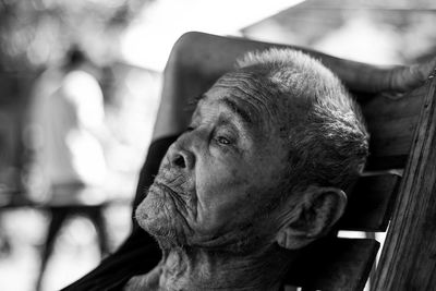 Close-up of senior man sitting on chair