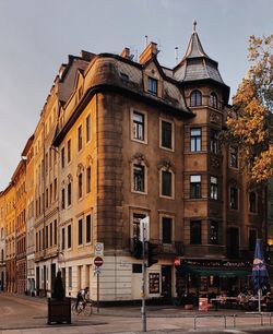 People on street against buildings in city