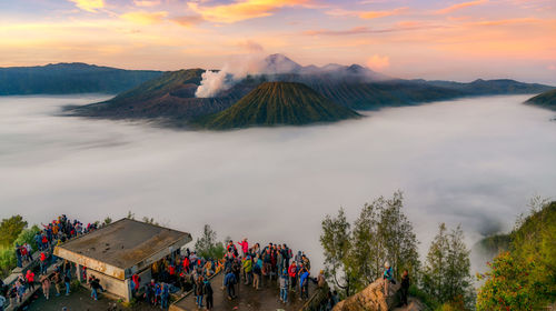 High angle view of people on mountains against sky during sunset