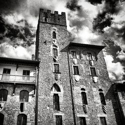 Low angle view of building against cloudy sky