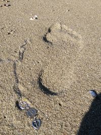 High angle view of footprints on beach