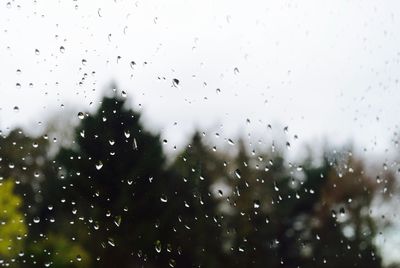 Full frame shot of wet window against clear sky