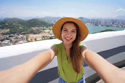 Tourist woman takes self portrait in vitoria city in the state of espirito santo, brazil